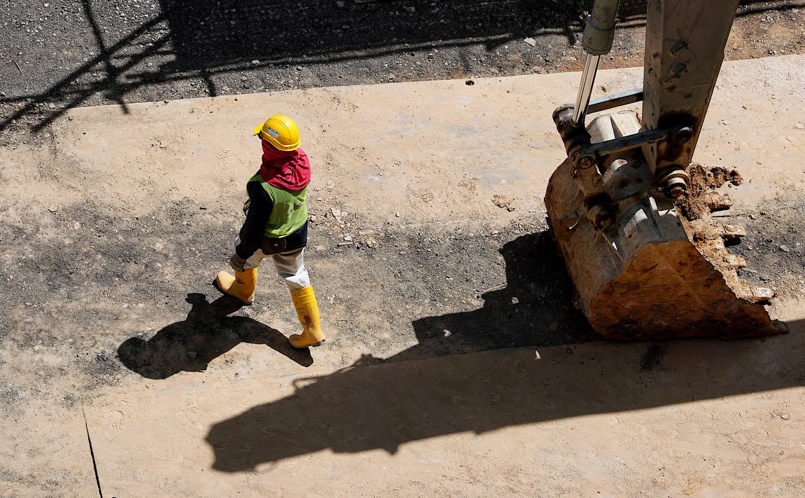 Construction worker beside an excavator; illustrative stock photograph, not a Silex client site